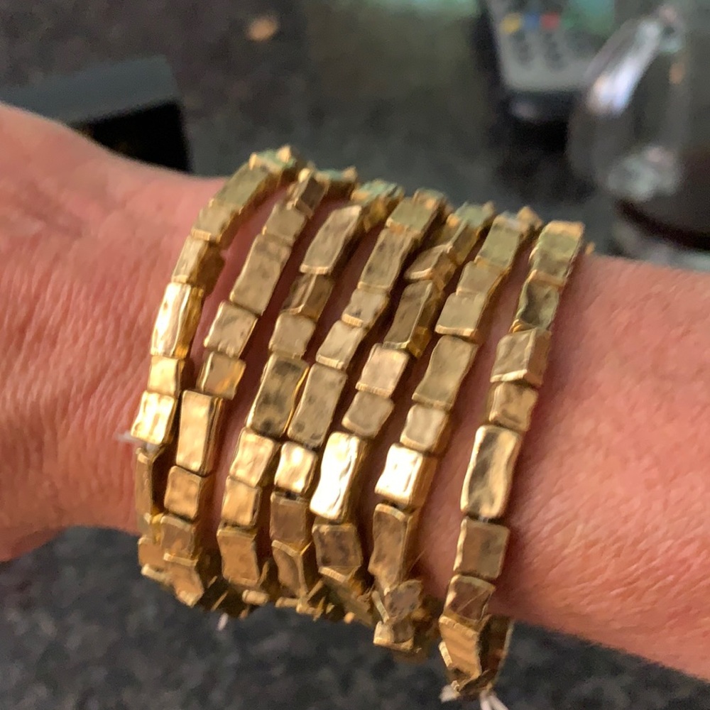 Stack of gold colored bracelets